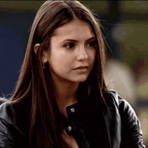 A Close Up Of A Woman 'S Face Wearing A Leather Jacket . GIF
