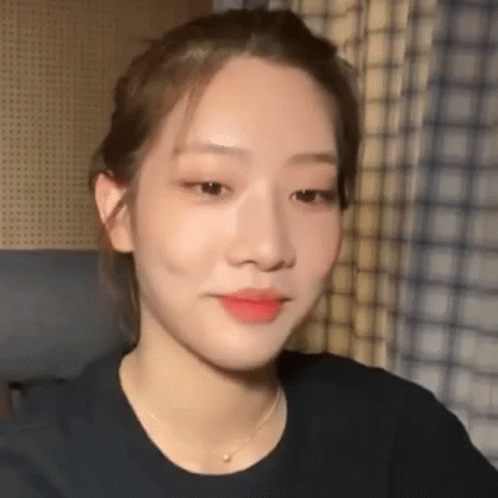A Close Up Of A Woman 'S Face Wearing A Necklace . GIF