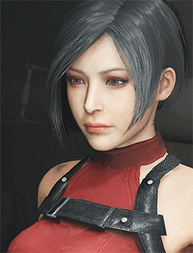 A Close Up Of A Woman 'S Face Wearing A Red Top And Black Harness GIF