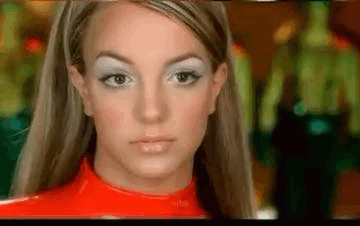 A Close Up Of A Woman 'S Face Wearing A Red Top And White Eye Shadow . GIF