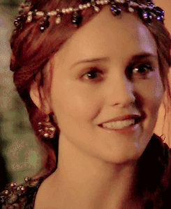 A Close Up Of A Woman 'S Face Wearing A Tiara And Smiling GIF