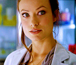 A Close Up Of A Woman 'S Face Wearing A White Jacket GIF