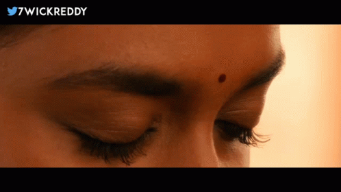 A Close Up Of A Woman 'S Face With 7Wickreddy In The Upper Right Corner GIF