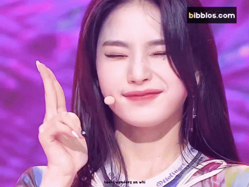 A Close Up Of A Woman 'S Face With A Bibbios.com Logo In The Background GIF