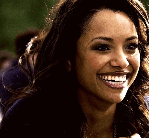 A Close Up Of A Woman 'S Face With A Big Smile On Her Face GIF