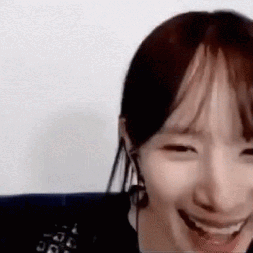 A Close Up Of A Woman 'S Face With A Big Smile On Her Face . GIF