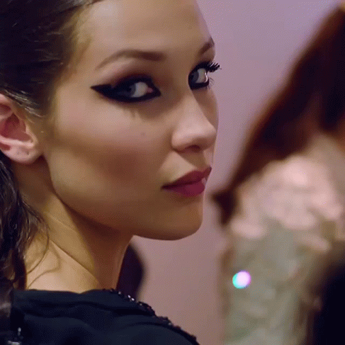 A Close Up Of A Woman 'S Face With A Black Eye Shadow GIF