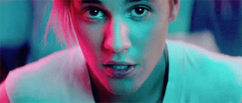A Close Up Of A Woman 'S Face With A Blue And Red Background . GIF