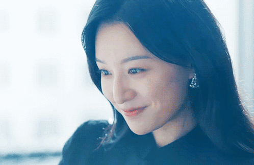 A Close Up Of A Woman 'S Face With A Blue Background GIF