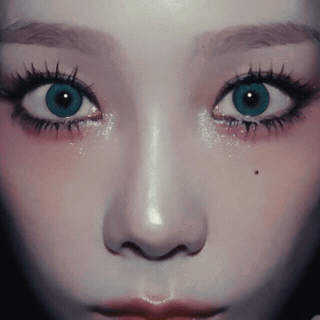 A Close Up Of A Woman 'S Face With A Blue Eye GIF