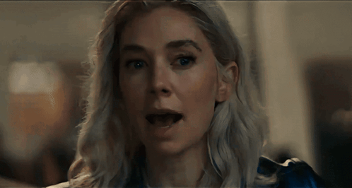 A Close Up Of A Woman 'S Face With A Blue Shirt On GIF