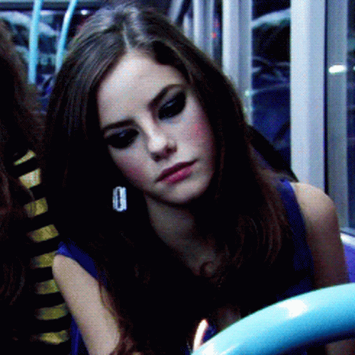 A Close Up Of A Woman 'S Face With A Blue Shirt On GIF