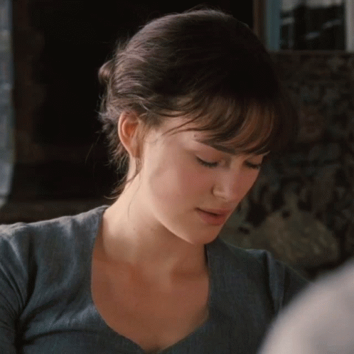 A Close Up Of A Woman 'S Face With A Blue Shirt On GIF