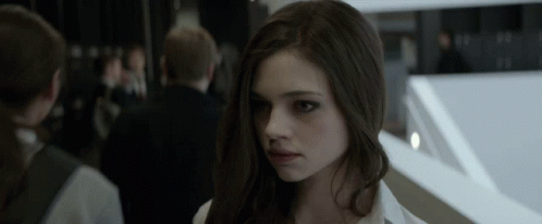A Close Up Of A Woman 'S Face With A Blurred Background GIF