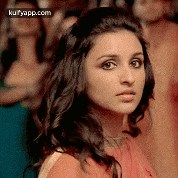 A Close Up Of A Woman 'S Face With A Blurred Background . GIF