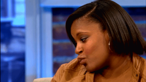 A Close Up Of A Woman 'S Face With A Blurred Background GIF