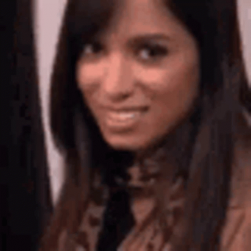 A Close Up Of A Woman 'S Face With A Blurred Background . GIF