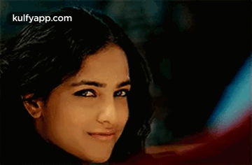 A Close Up Of A Woman 'S Face With A Blurred Background . GIF