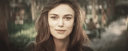 A Close Up Of A Woman 'S Face With A Blurred Background . GIF