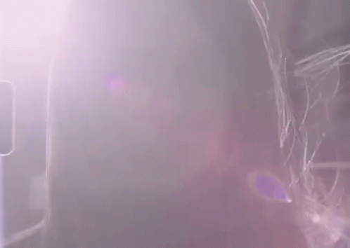 A Close Up Of A Woman 'S Face With A Blurred Background GIF