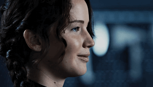A Close Up Of A Woman 'S Face With A Braid GIF