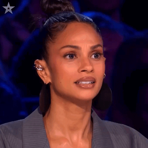 Close Up Of Woman's Face With Bun And Earrings GIF