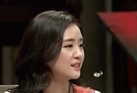A Close Up Of A Woman 'S Face With A Butterfly Flying Over Her Head . GIF