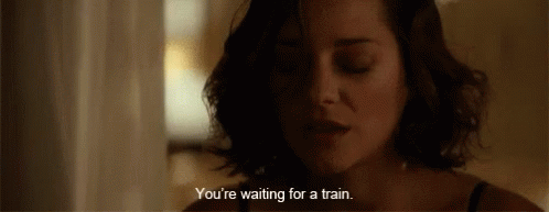 A Close Up Of A Woman 'S Face With A Caption That Says You 'Re Waiting For A Train GIF
