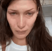 A Close Up Of A Woman 'S Face With A Crying Look On Her Face . GIF