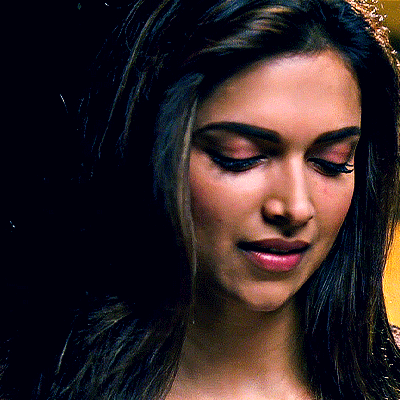 A Close Up Of A Woman 'S Face With A Dark Background GIF