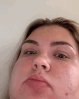 A Close Up Of A Woman 'S Face With A Funny Face . GIF