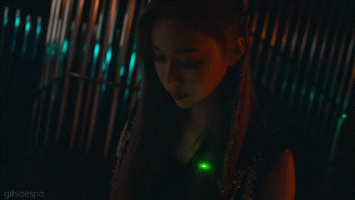 a close up of a woman 's face with a green light in her hair