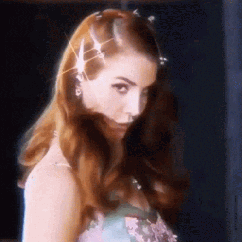 A Close Up Of A Woman 'S Face With A Hair Clip On Her Head GIF