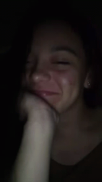 A Close Up Of A Woman 'S Face With A Hand On Her Face GIF