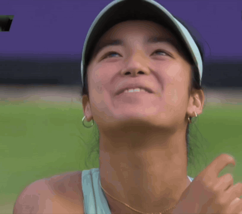 A Close Up Of A Woman 'S Face With A Hat On GIF