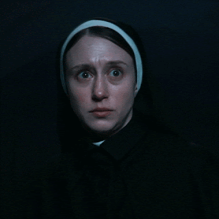A Close Up Of A Woman 'S Face With A Headband On GIF