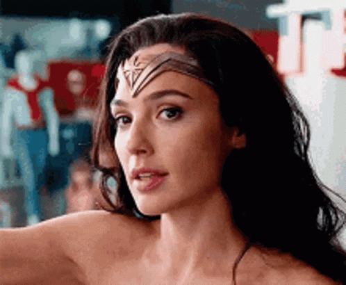 A Close Up Of A Woman 'S Face With A Headband On . GIF