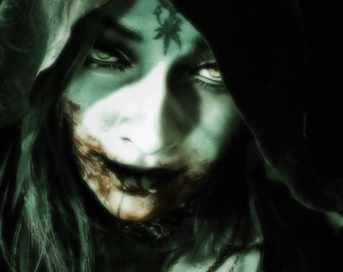 A Close Up Of A Woman 'S Face With A Hood On Her Head GIF