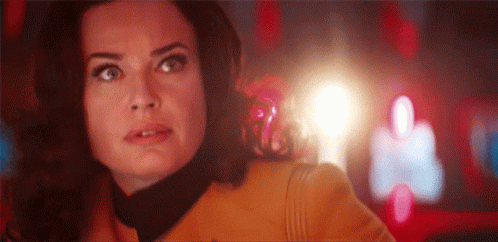 A Close Up Of A Woman 'S Face With A Light Coming Out Of Her Mouth . GIF