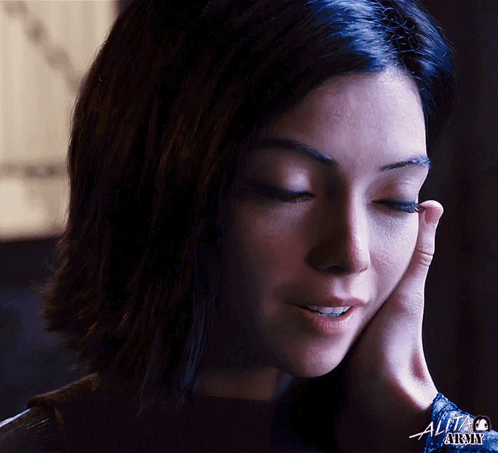 A Close Up Of A Woman 'S Face With A Little Alchemy Logo Visible GIF
