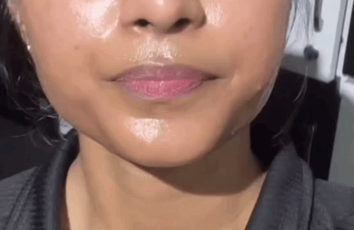 A Close Up Of A Woman 'S Face With A Lot Of Oil On Her Face . GIF