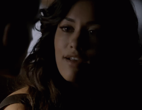 A Close Up Of A Woman 'S Face With A Man Behind Her GIF