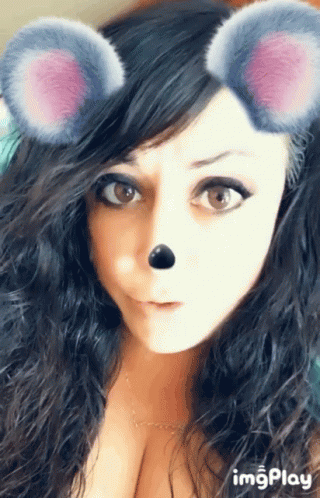 a close up of a woman 's face with a mouse mask on