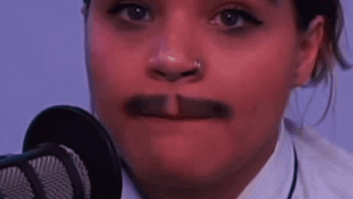 A Close Up Of A Woman 'S Face With A Mustache . GIF
