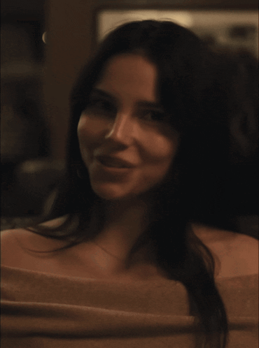 A Close Up Of A Woman 'S Face With A Necklace On GIF