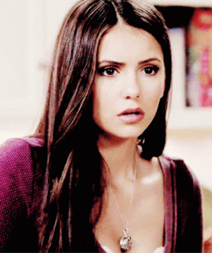 A Close Up Of A Woman 'S Face With A Necklace On Her Neck GIF