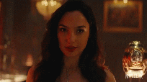 A Close Up Of A Woman 'S Face With A Necklace On . GIF
