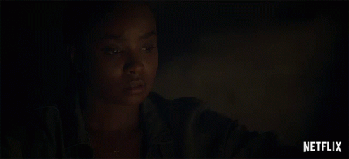 A Close Up Of A Woman 'S Face With A Netflix Logo Behind Her GIF