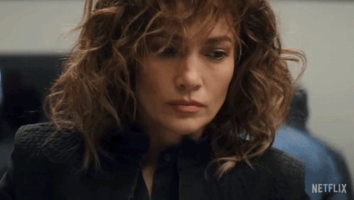 Close Up Of Woman's Face With Netflix Logo Behind GIF