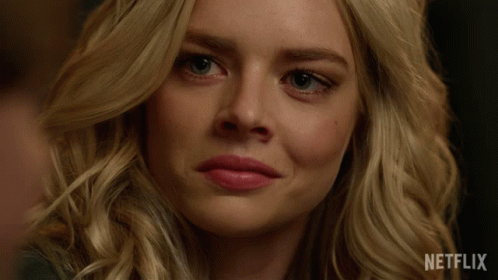 A Close Up Of A Woman 'S Face With A Netflix Logo On The Bottom GIF